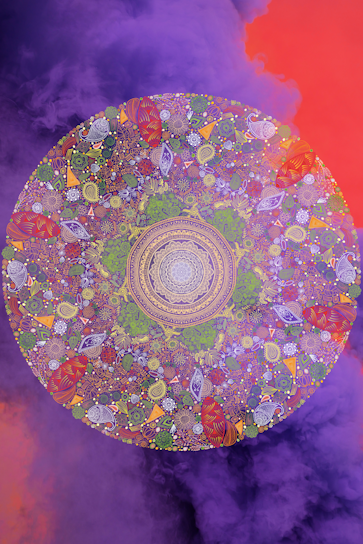 A vibrant mandala with intricate patterns, featuring a combination of floral and geometric designs. The mandala is filled with vivid colors, primarily purples, greens, and reds, and is set against a background of swirling purple and orange clouds, creating a mystical and dreamlike atmosphere.