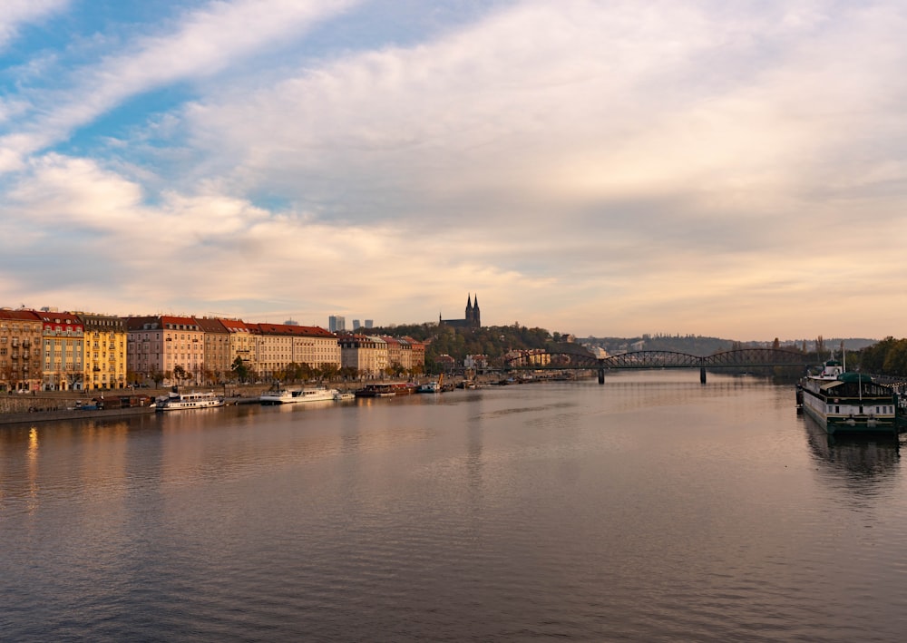 a river with a boat in it and buildings in the back