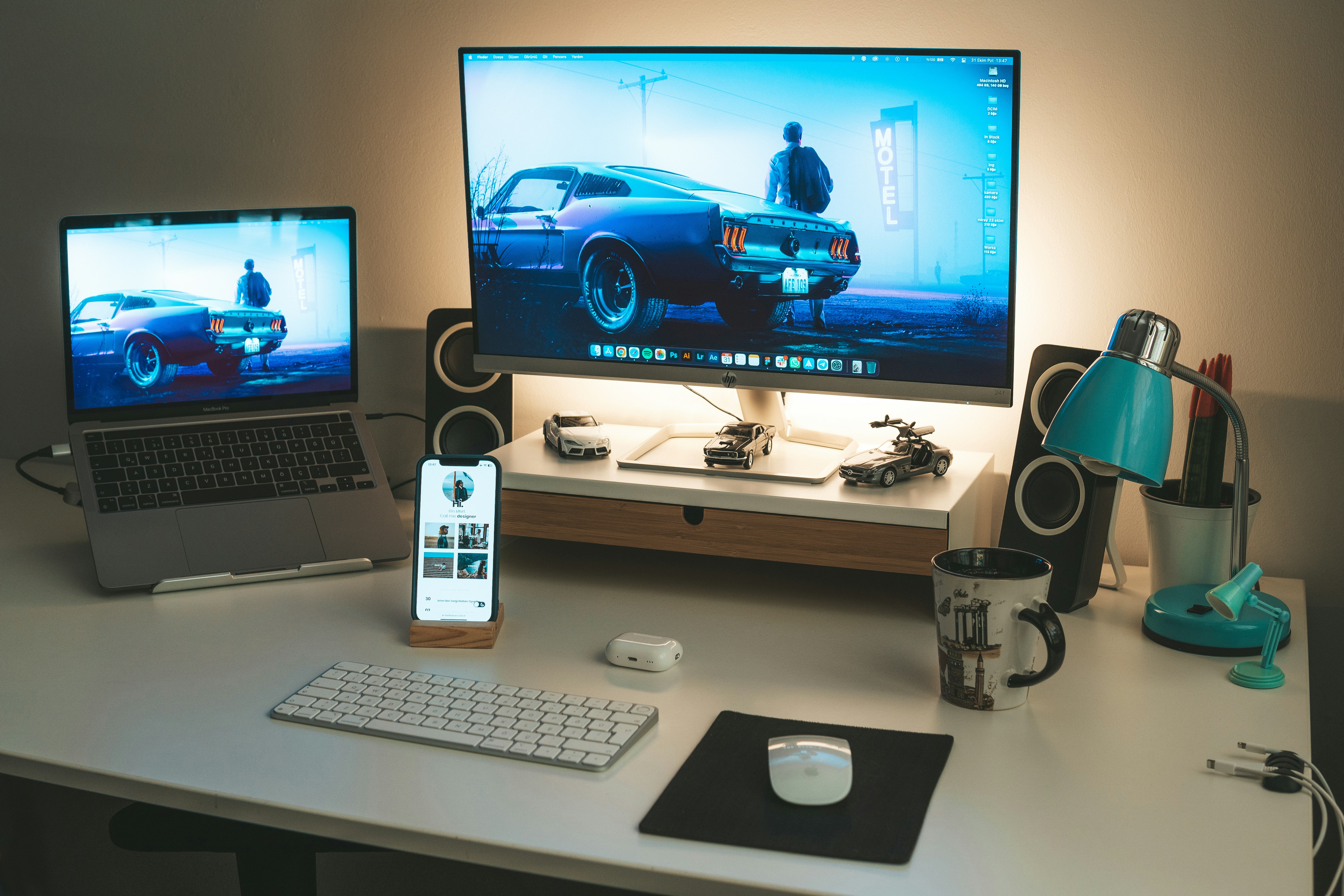 a desk with a laptop and a computer monitor