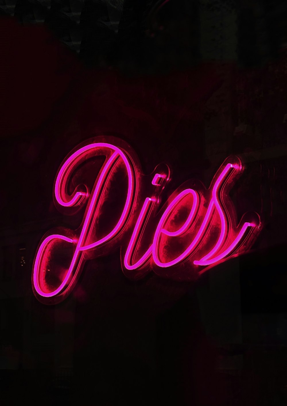 a neon sign with pink text