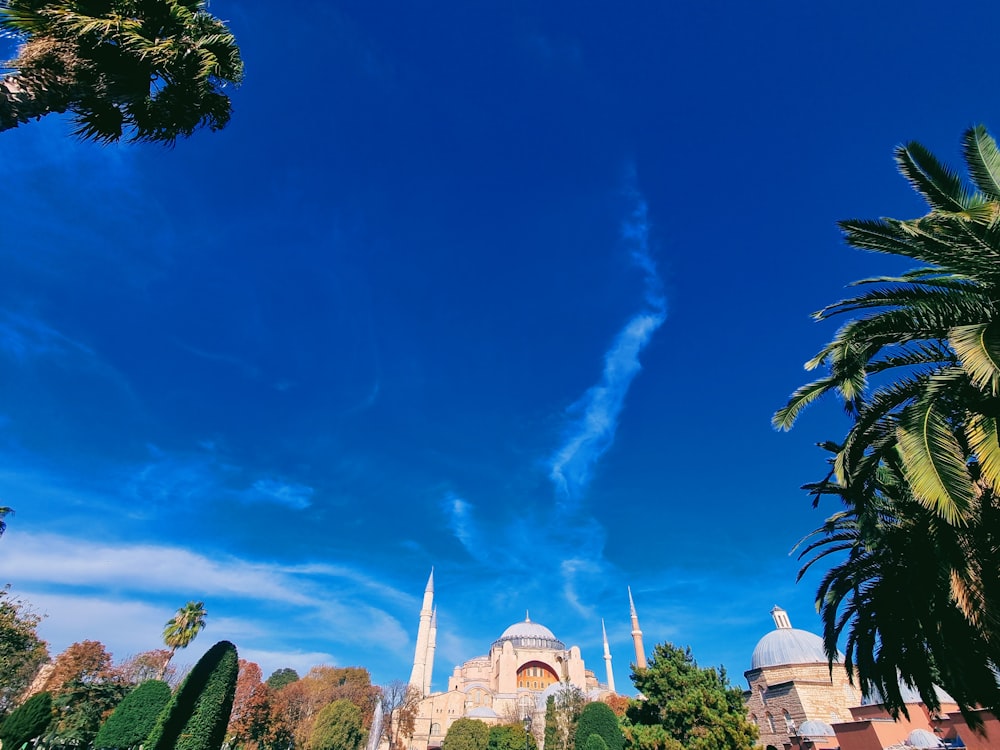 a blue sky with clouds and trees