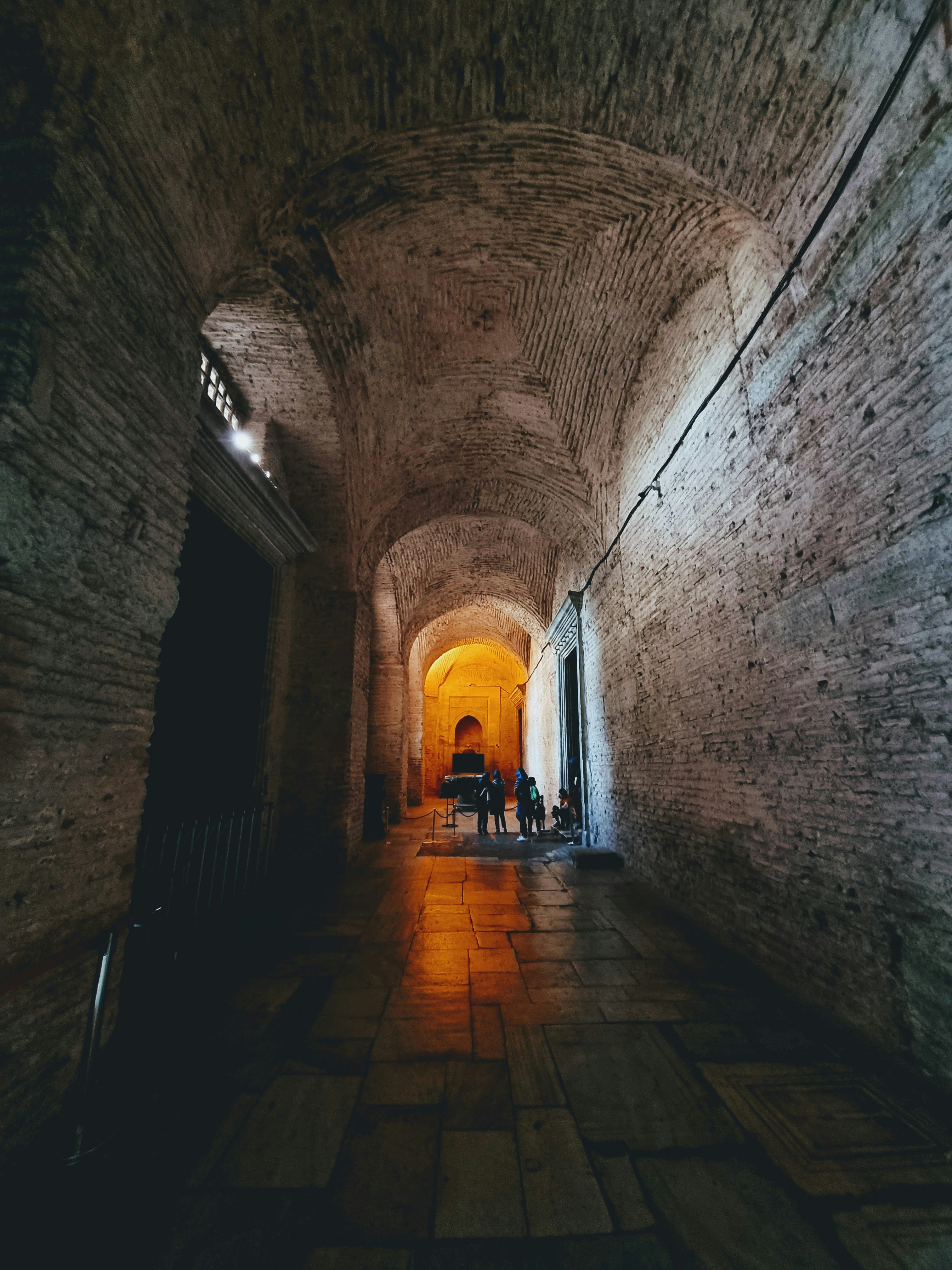 a group of people walking through a tunnel