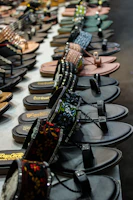 Comfortable sandals and flip-flops displayed on a sandy beach backdrop.