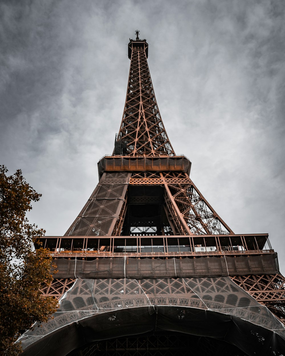 a tall metal tower with Eiffel Tower in the background