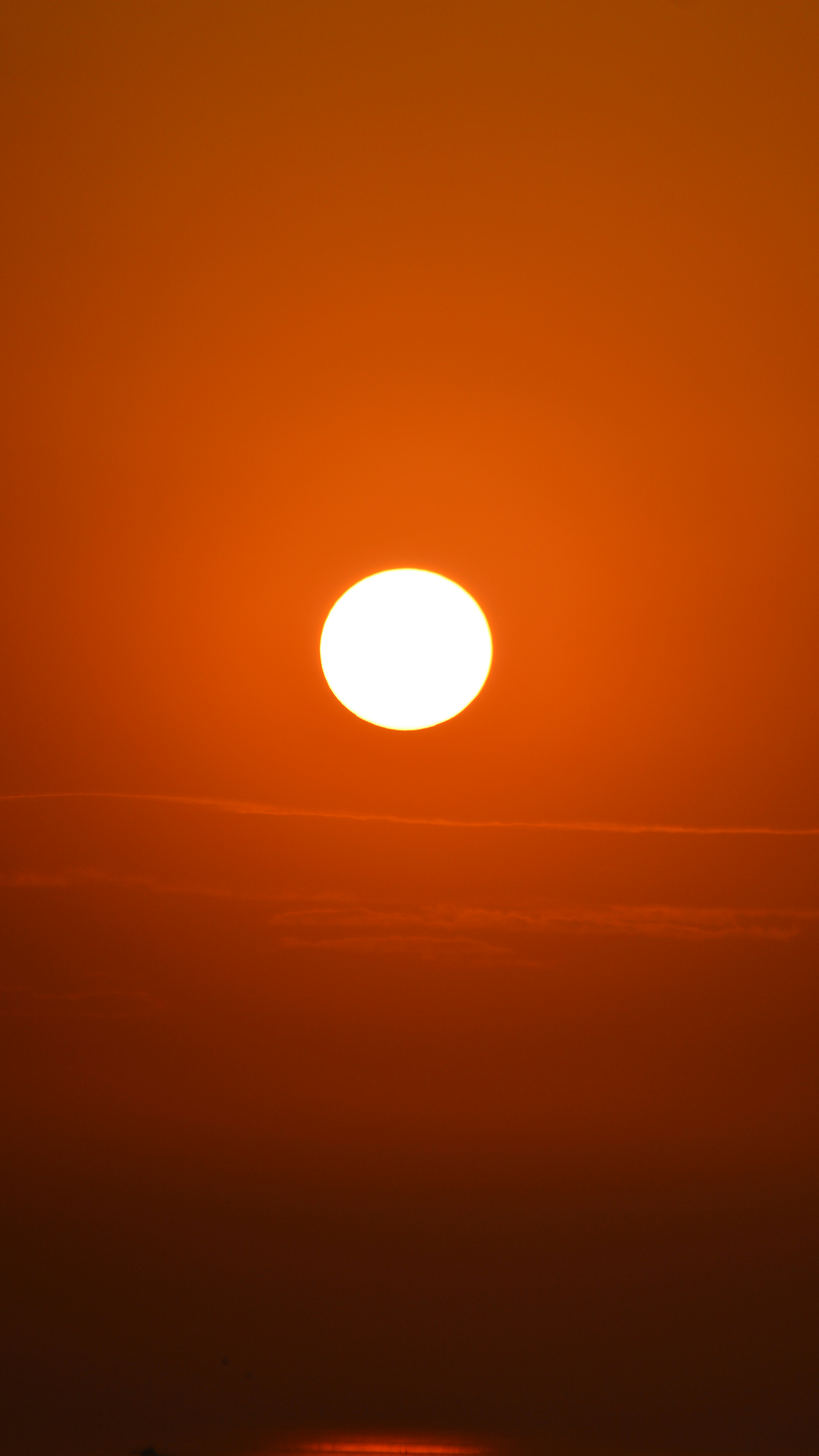 a sunset with a yellow sun