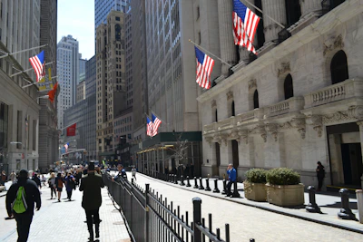 people walking on a street with flags