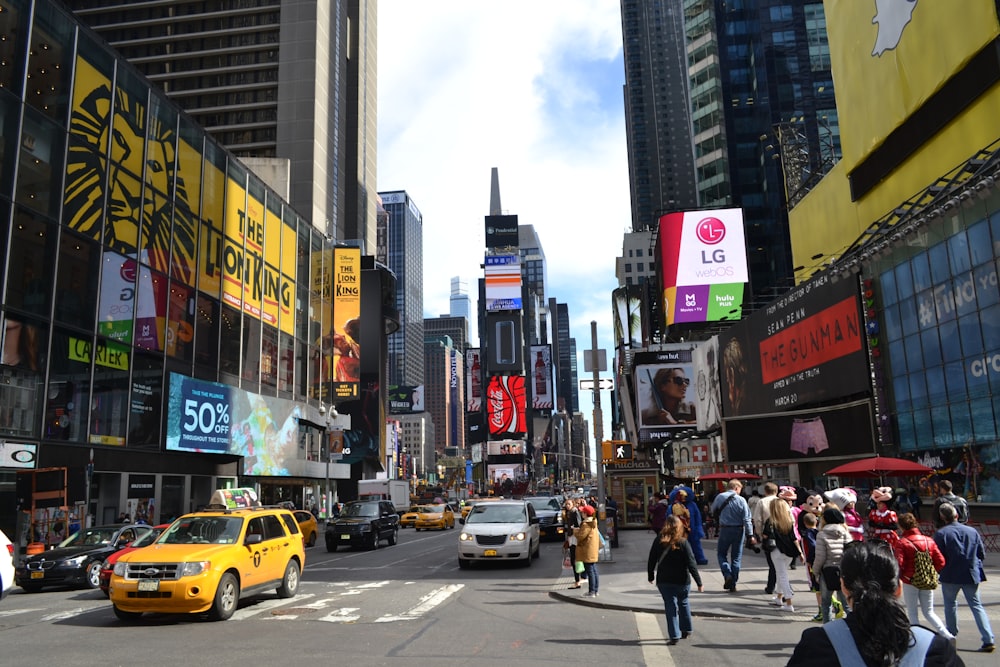 a busy city street with Times Square in the background