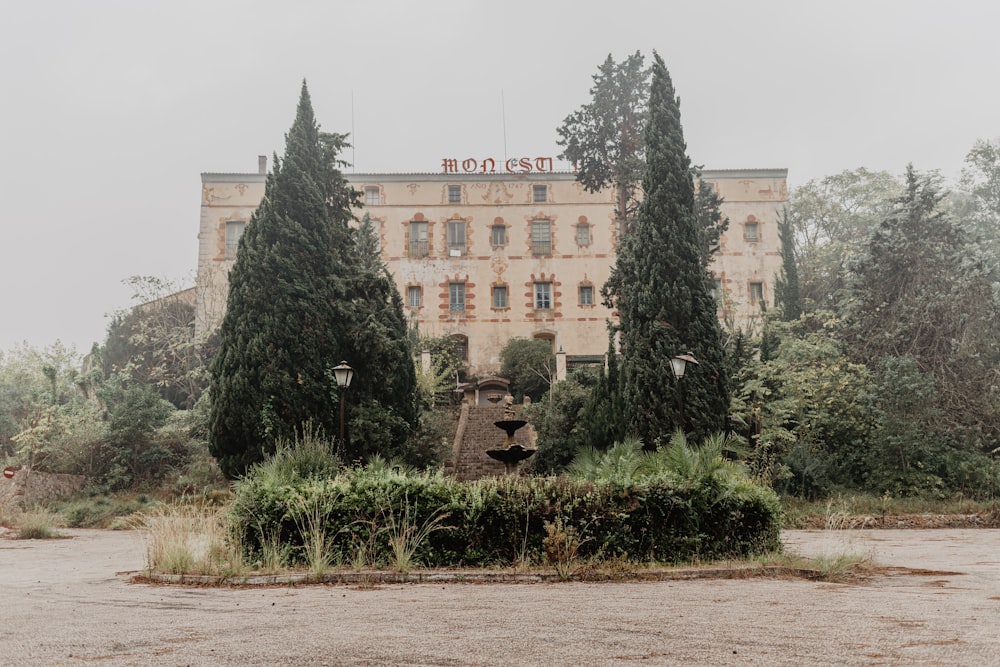 a large building with trees in front of it