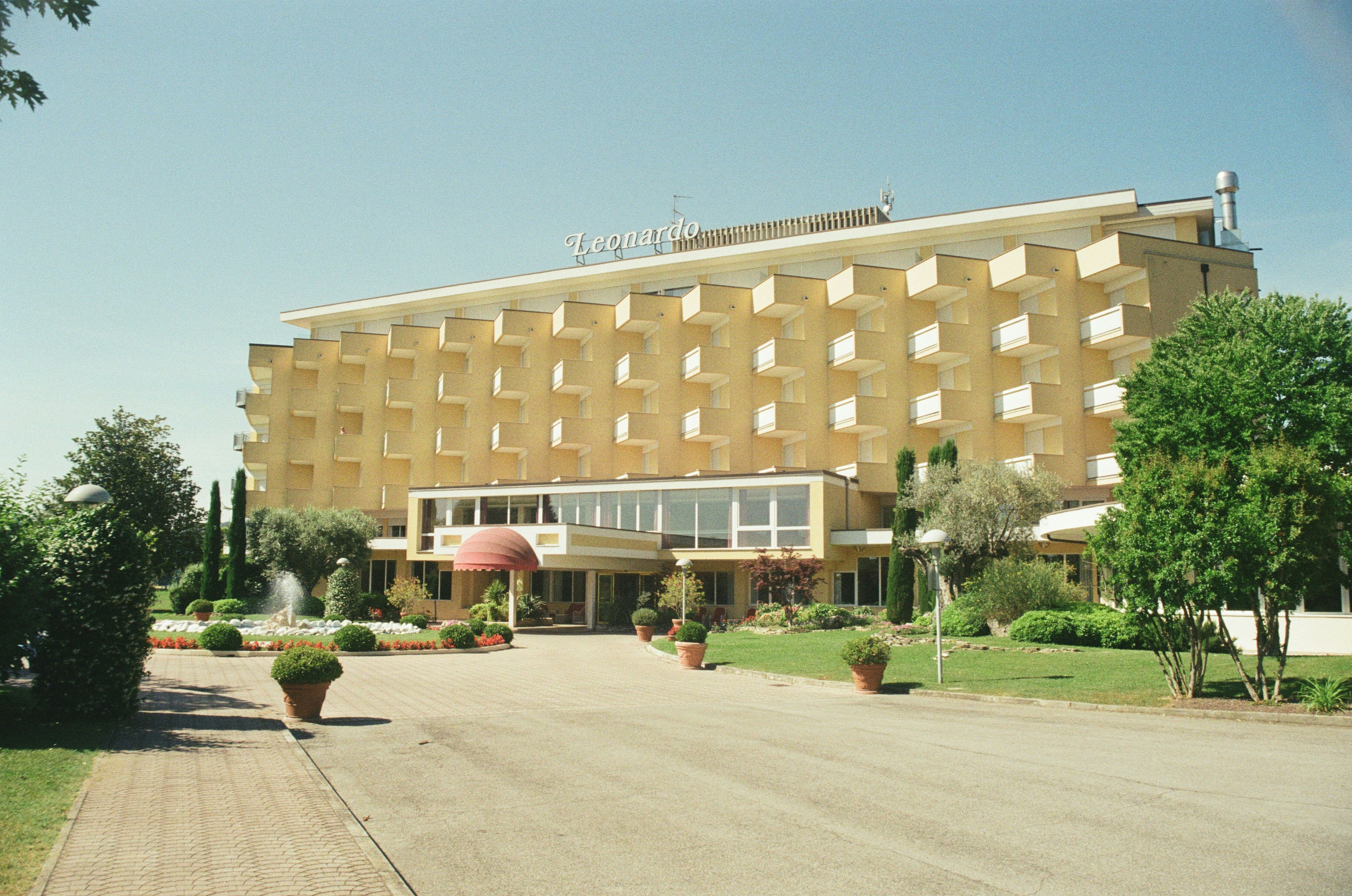 a building with trees and bushes in front of it
