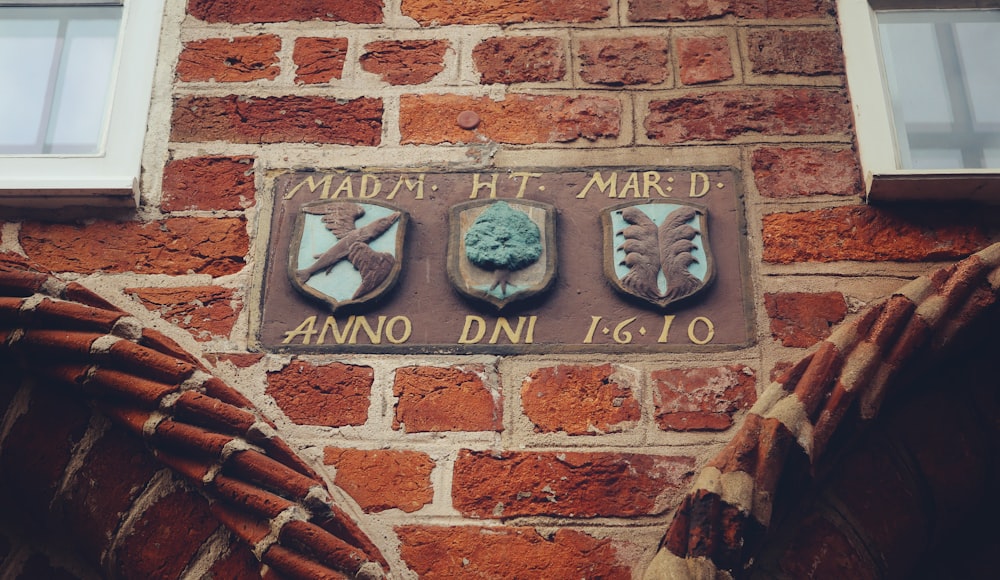 a sign on a brick wall