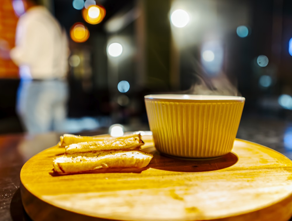 a bowl of food next to a cup of liquid