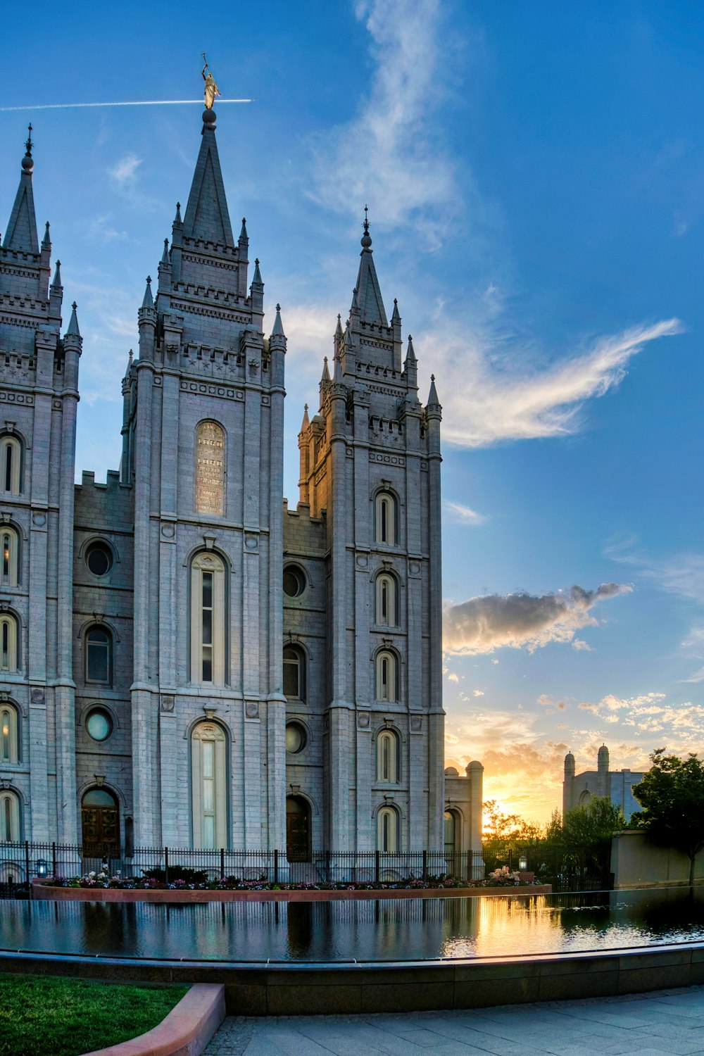 a large white building with towers with Salt Lake Temple in the background