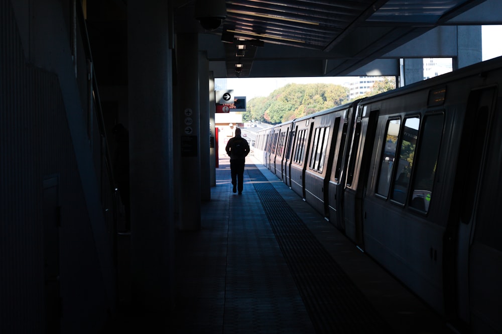 a person walks down a train platform