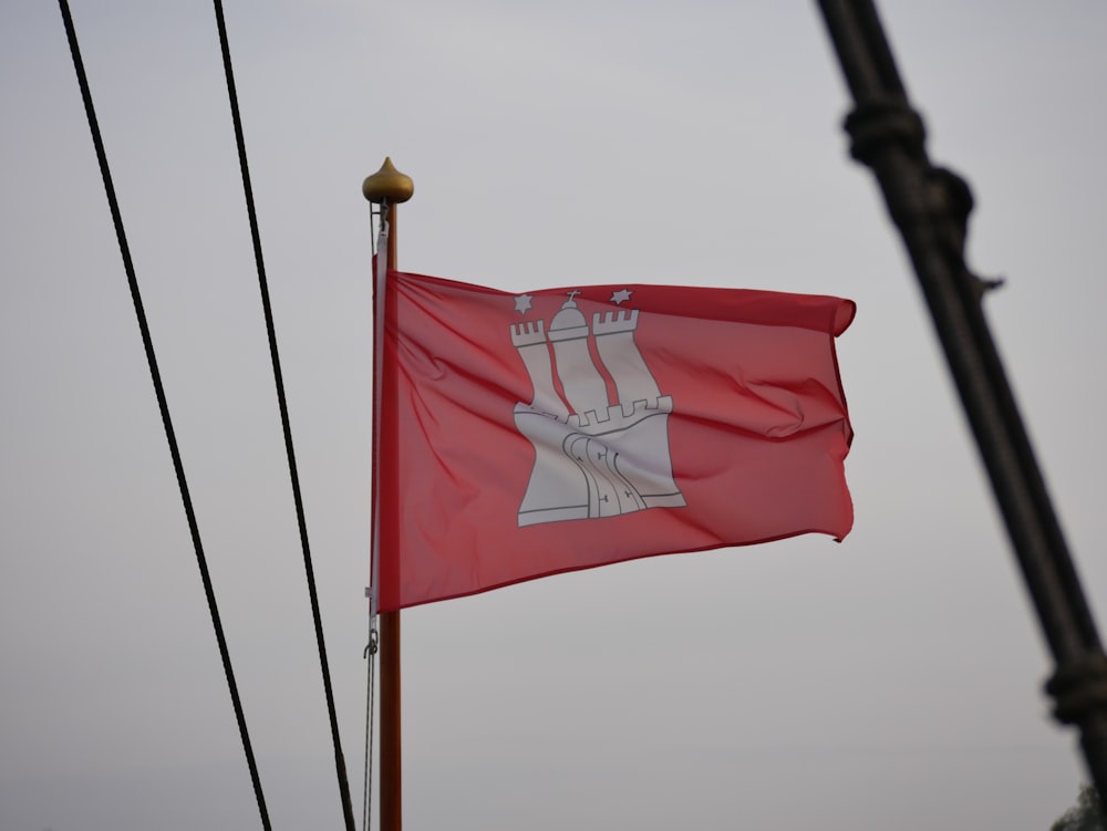 a red flag with a white cross on it