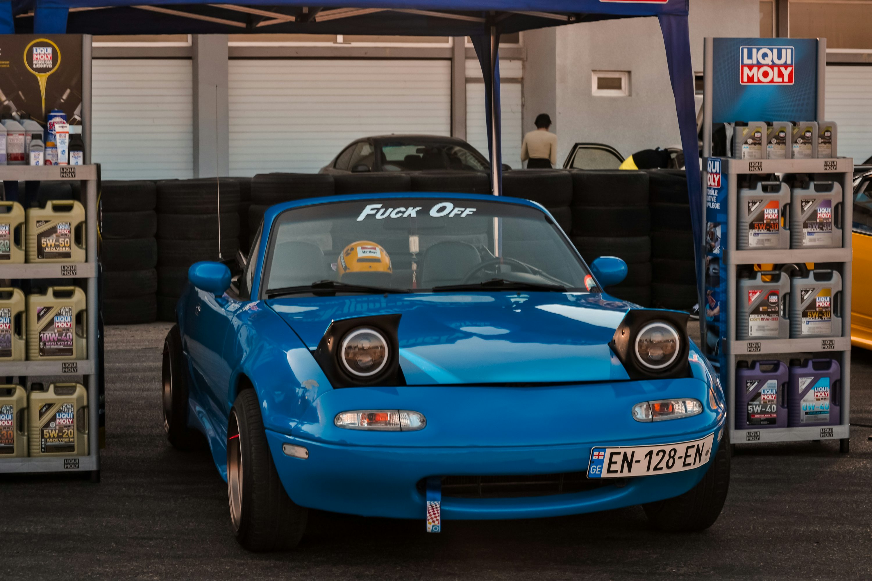 a blue car in a garage