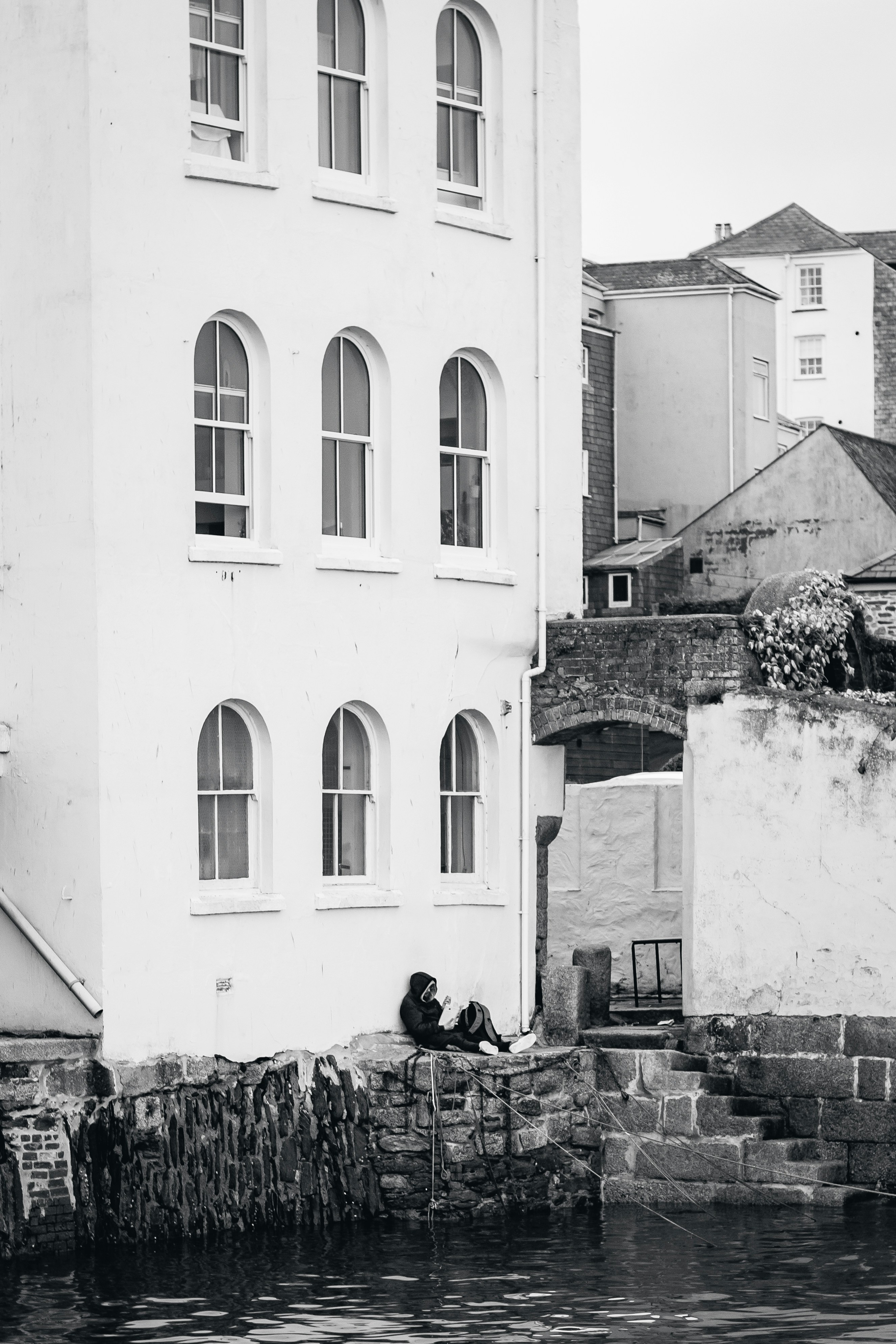 a white building with a stone wall