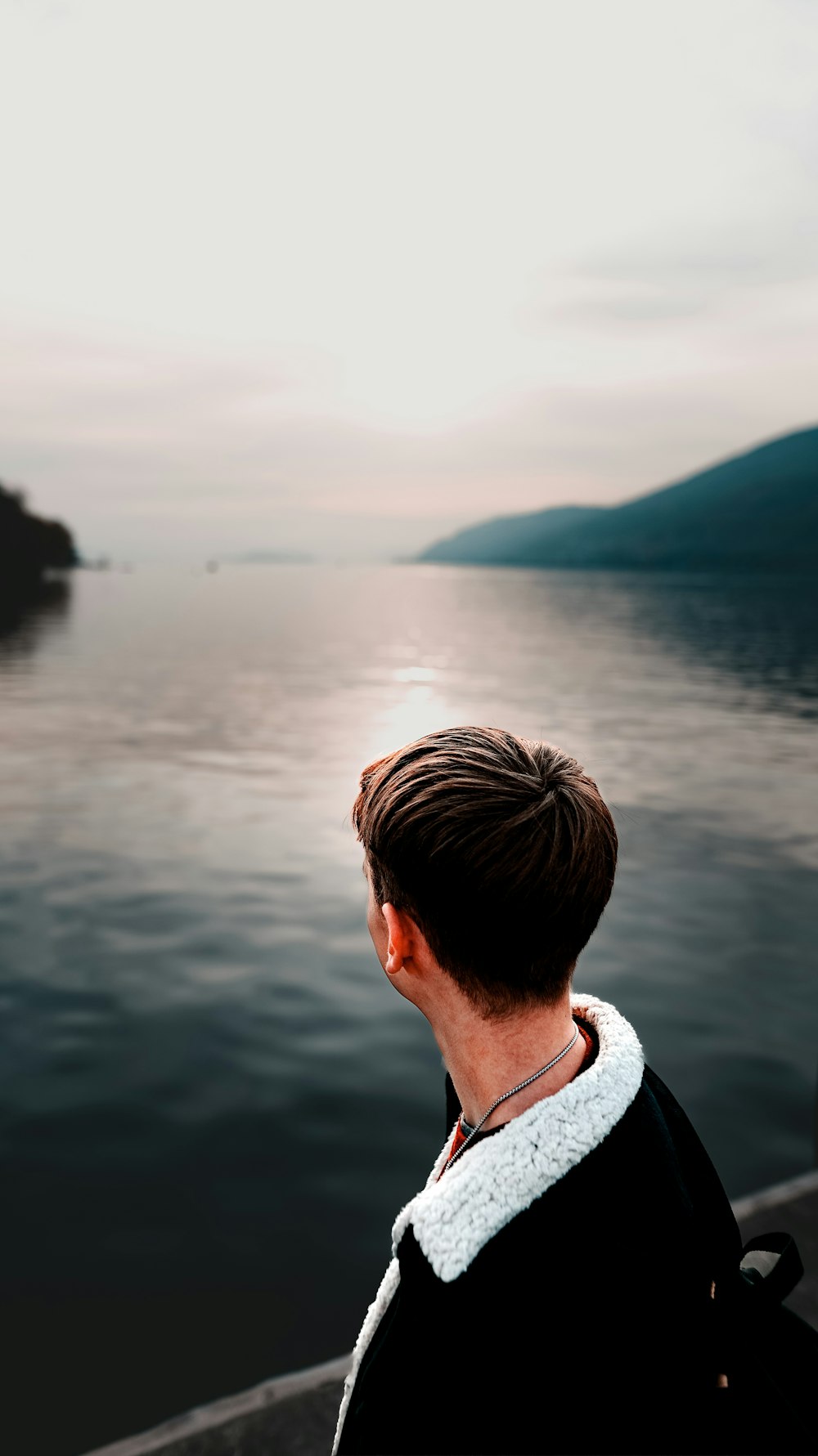 a person looking out over water