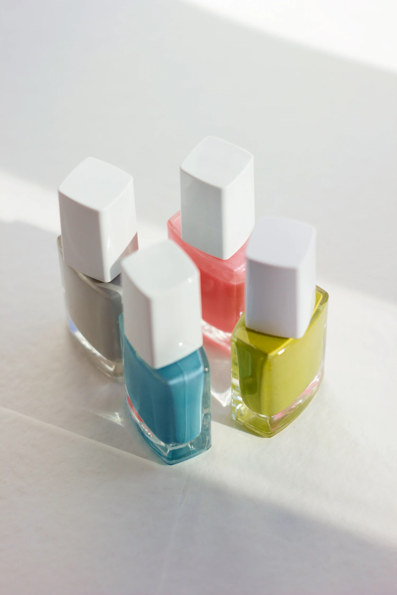 Mirrorball Chrome Polish, four unlabelled bottles standing on a white table — in stock