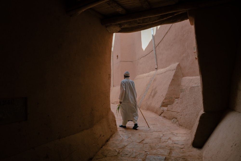 a man walking down a stone staircase