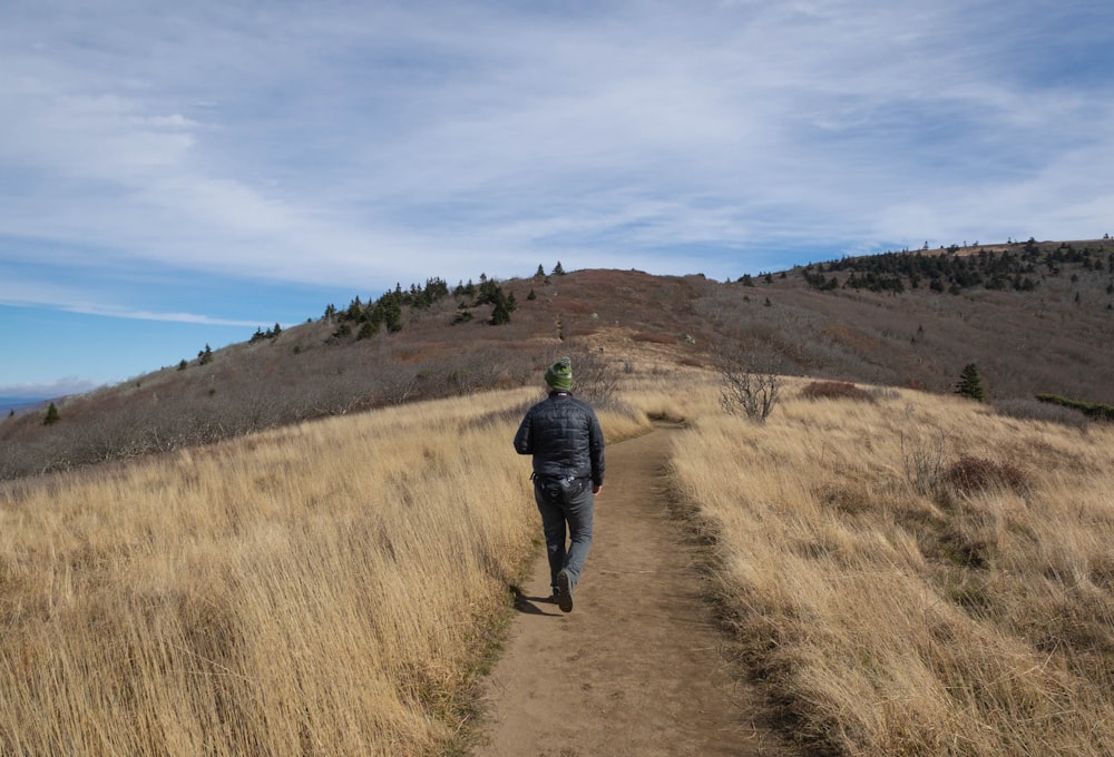 a person walking on a dirt path