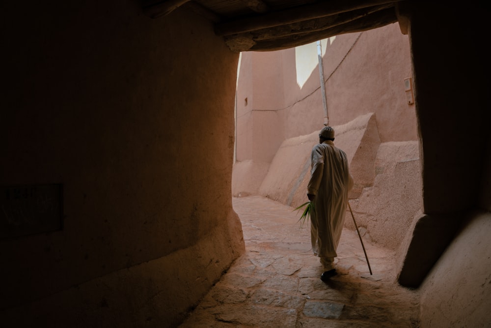 a person walking in a narrow alley
