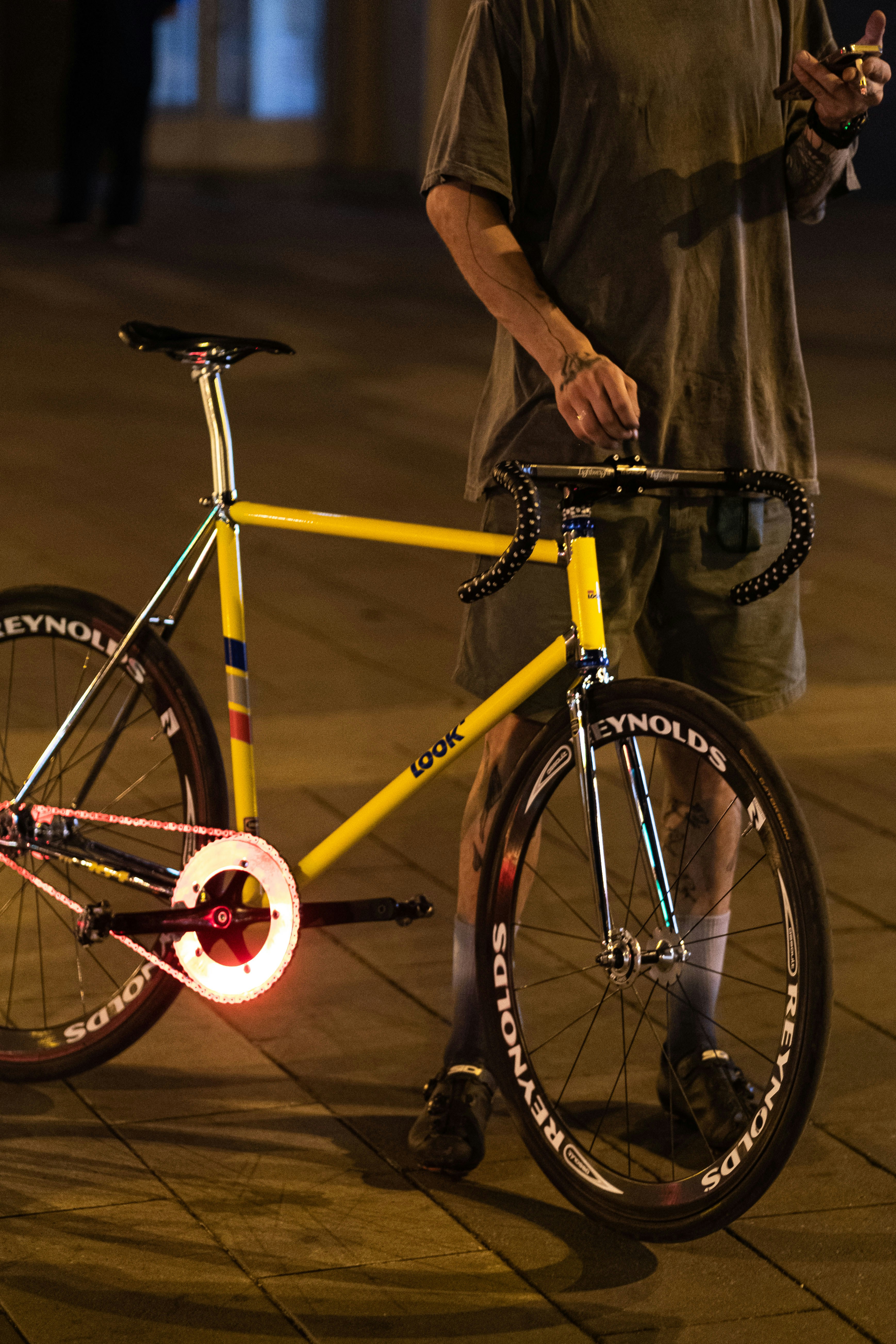a man standing next to a bicycle