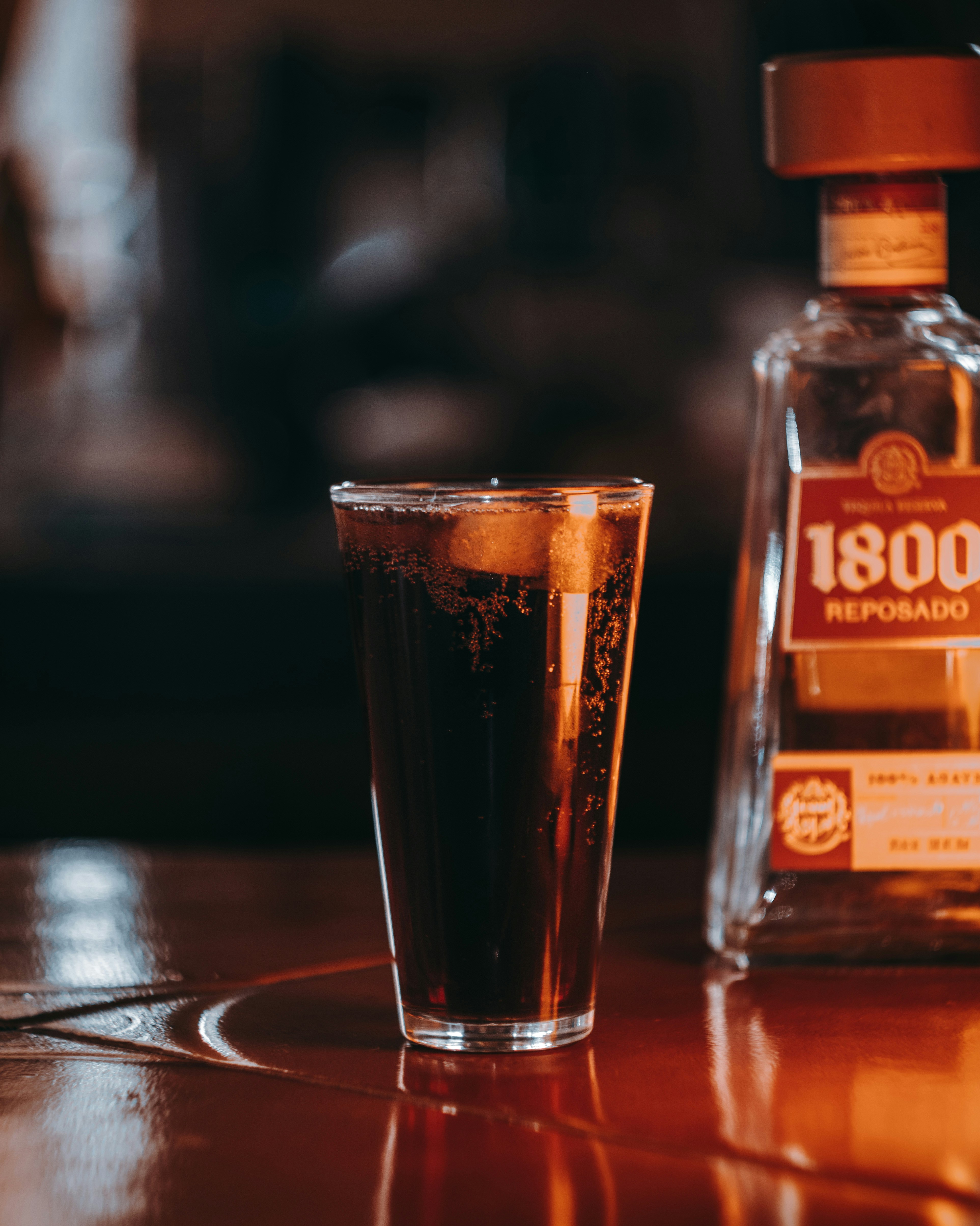 a glass of beer next to a bottle of beer