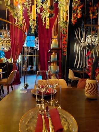 Elegant restaurant interior with maroon luxury decor and gourmet dishes displayed.