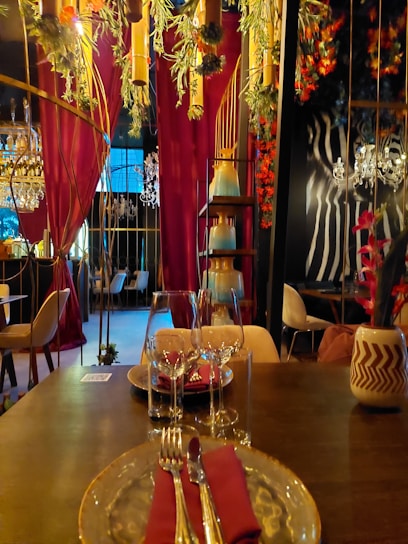 An elegant restaurant interior showcasing a variety of dining settings and decor.