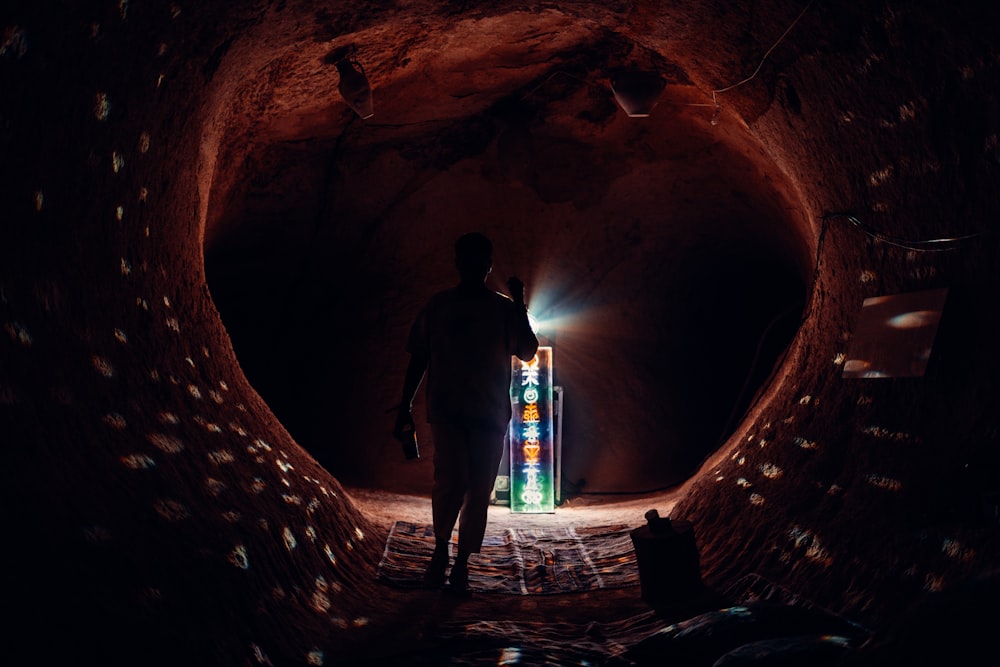 a man walking through a cave