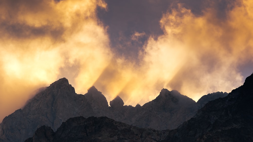 a mountain range with clouds