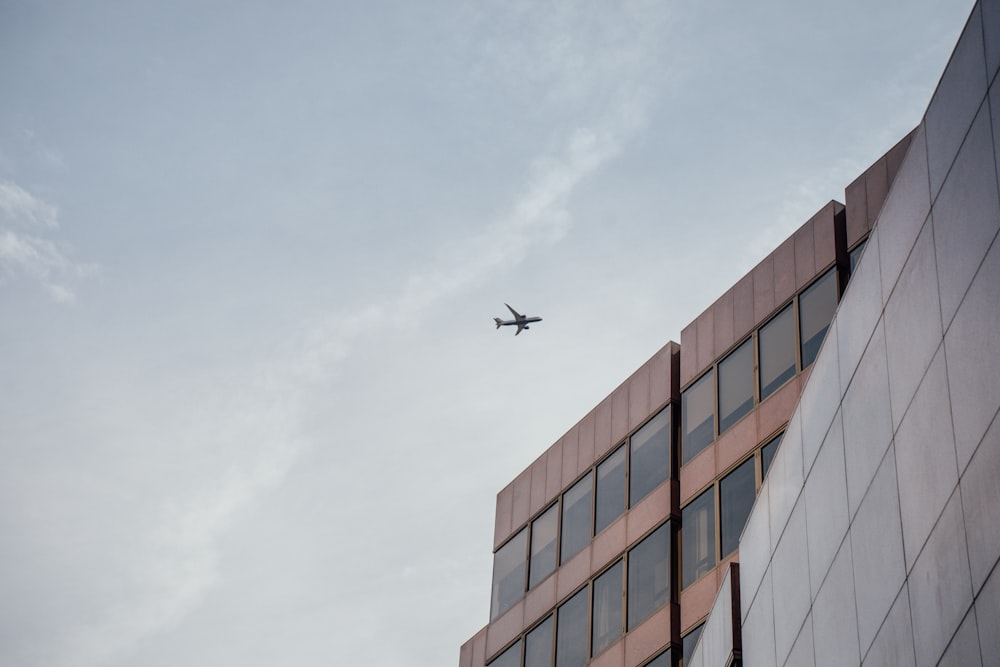 a plane flying over a building