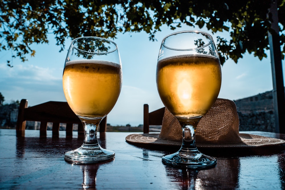 two glasses of beer on a table