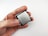 A close-up view of a person holding a computer processor, featuring an Intel Core i9 label. The processor is held between the thumb and index finger, with a plain white background creating a clean and minimalistic setting.