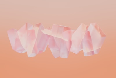 Abstract shapes in warm peach and soft aqua layered over a clean white background.