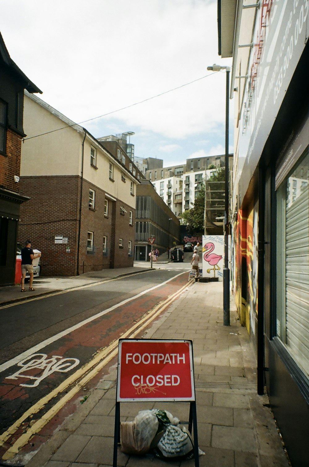 a stop sign on the sidewalk