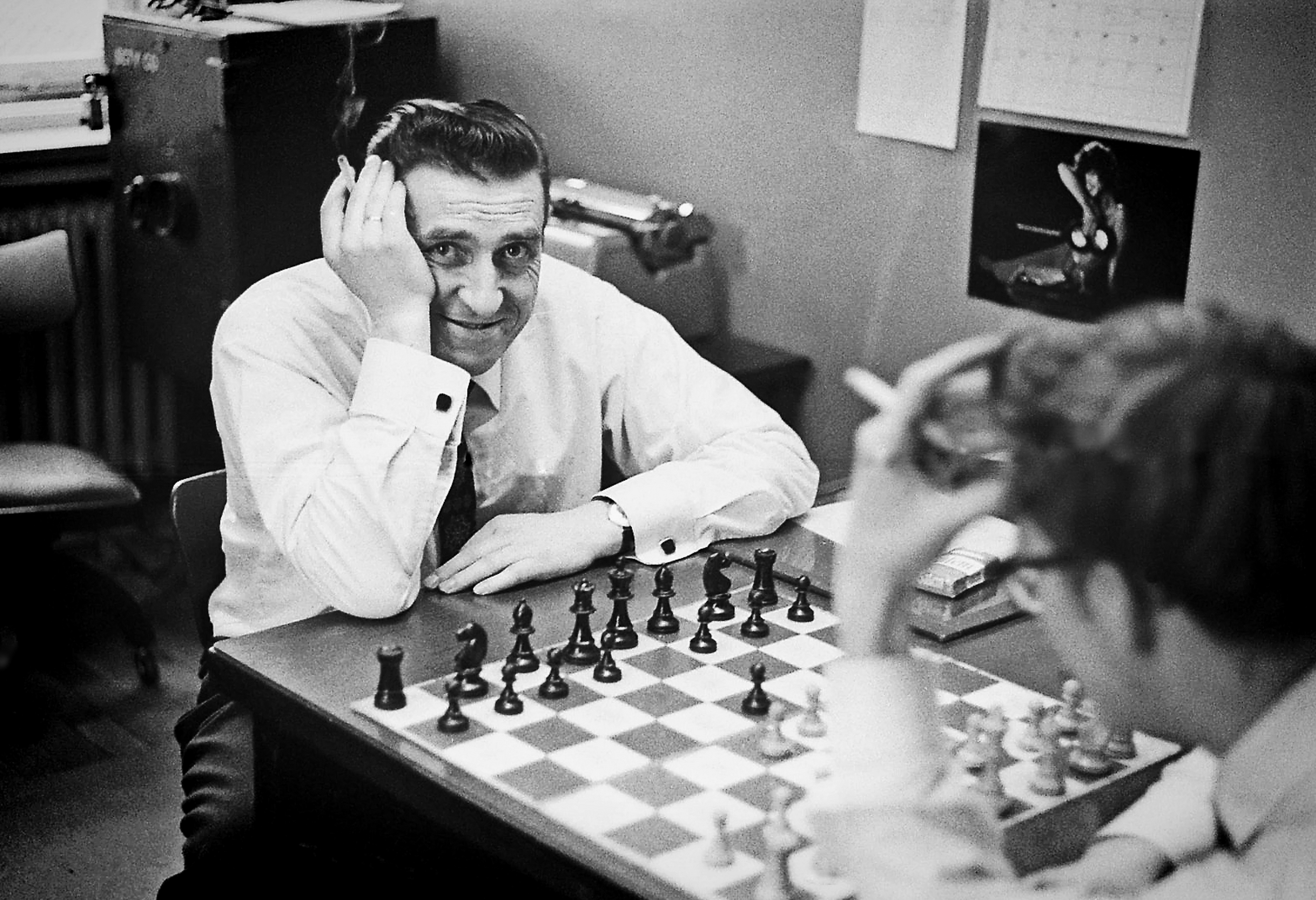a man playing chess with another man