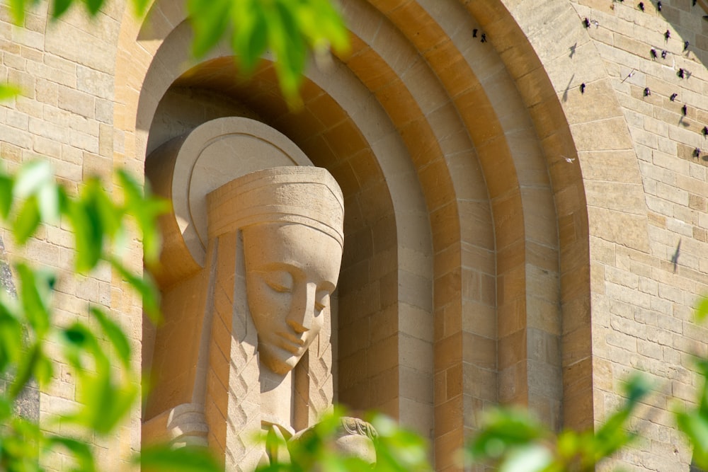 a stone archway with a face carved into it