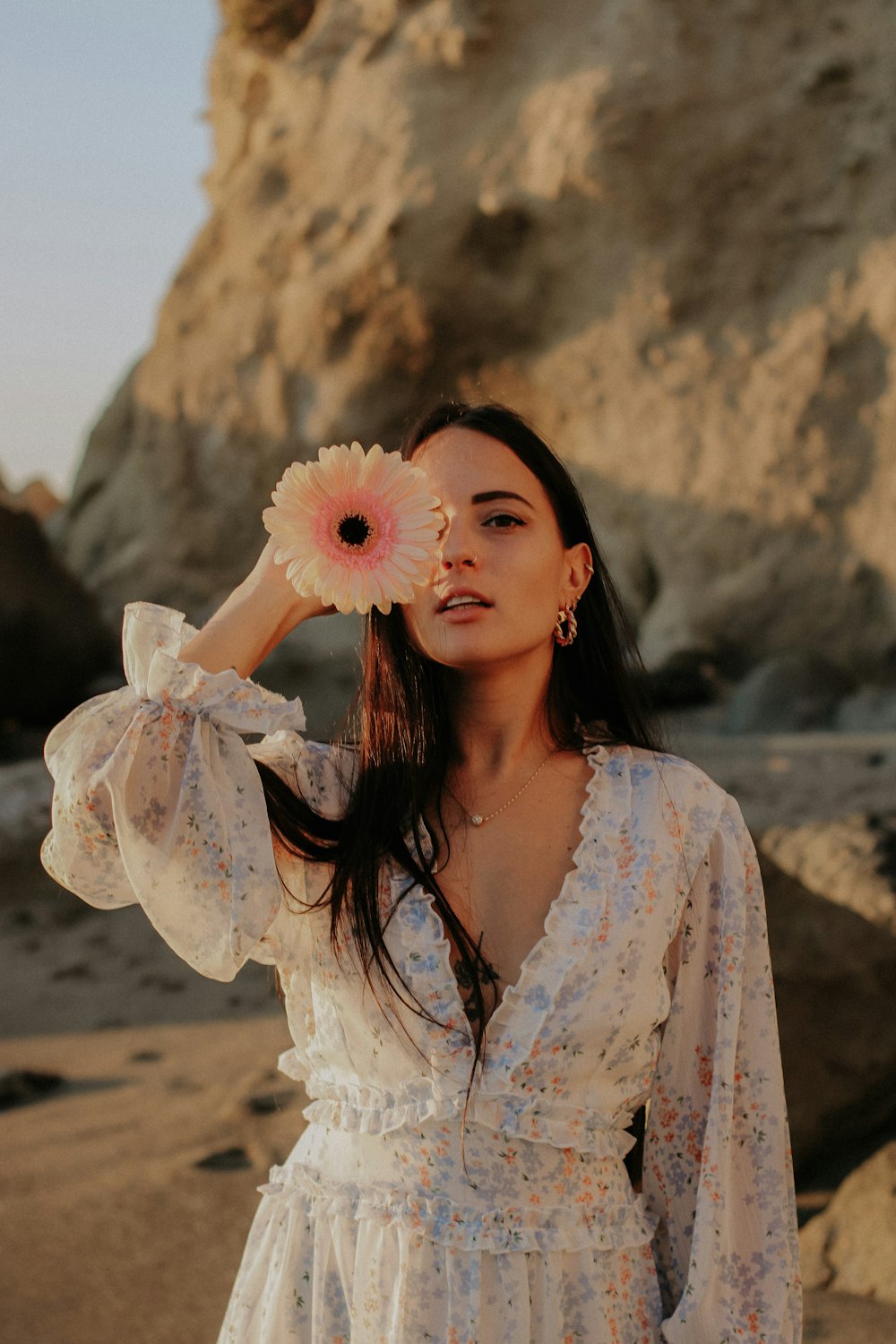 a woman in a white dress with a flower in her hair