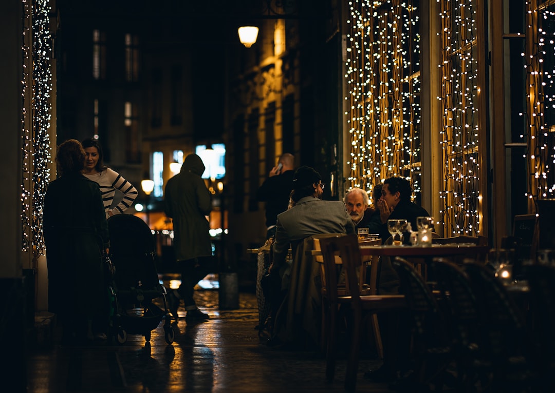 people sitting at tables in a bar,