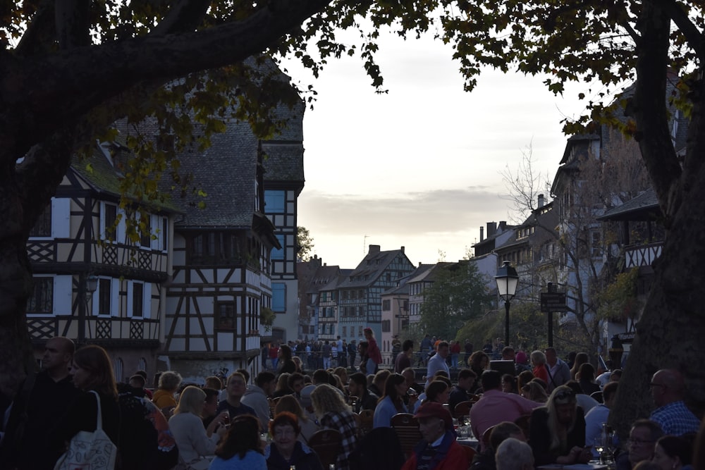 a crowd of people walking through a town