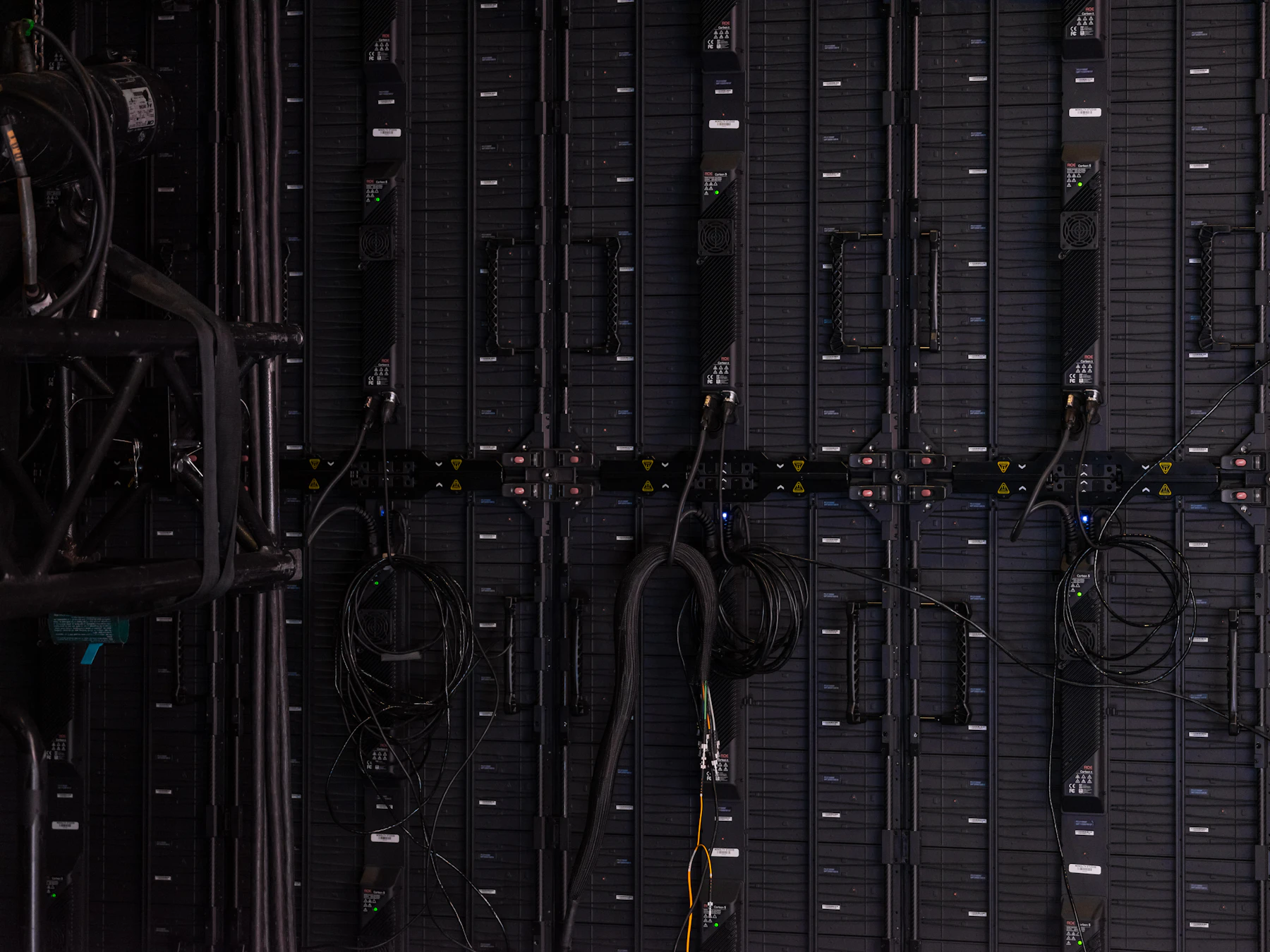 Dense rows of server equipment and network cables in a data center