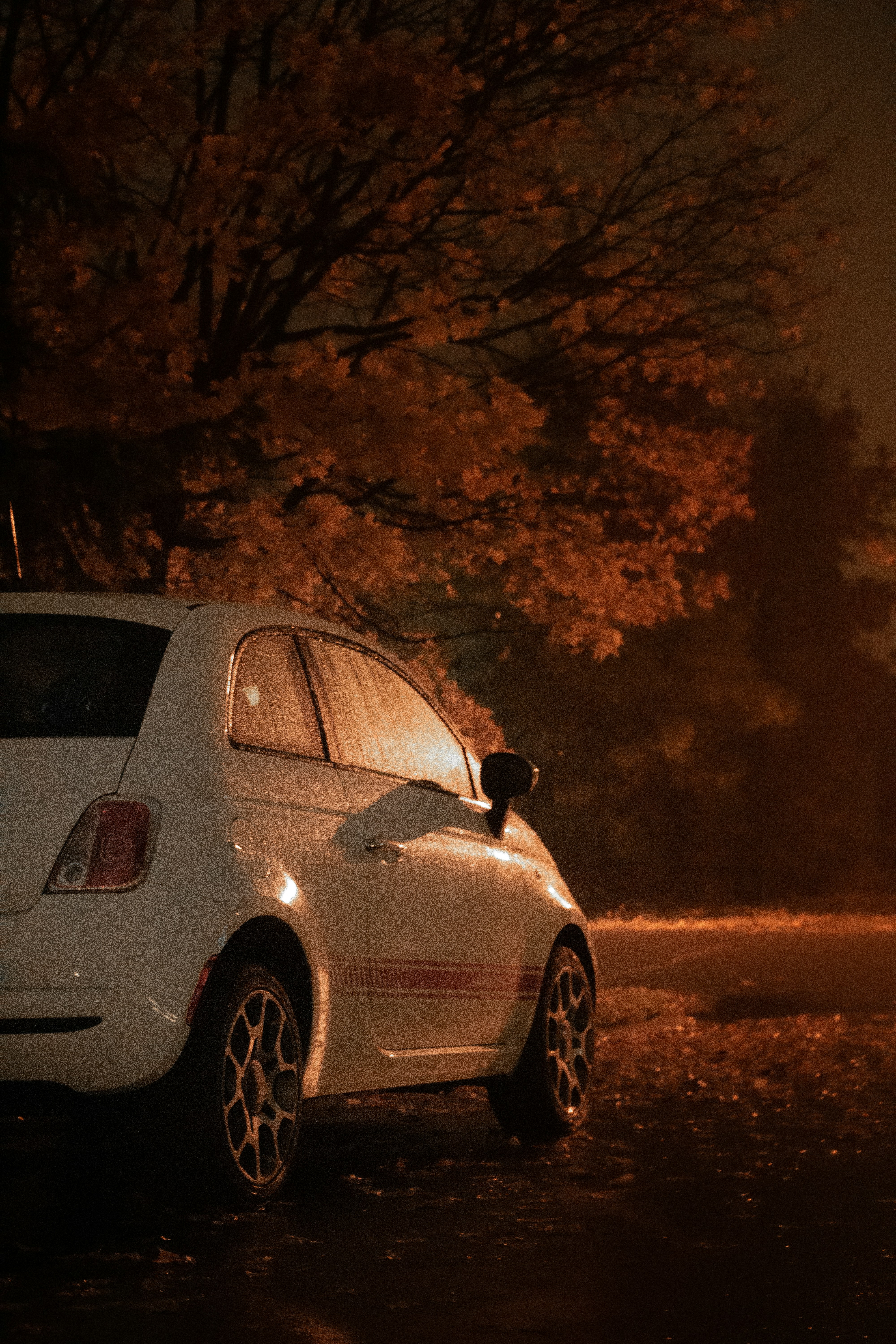 a white car parked in front of a fire