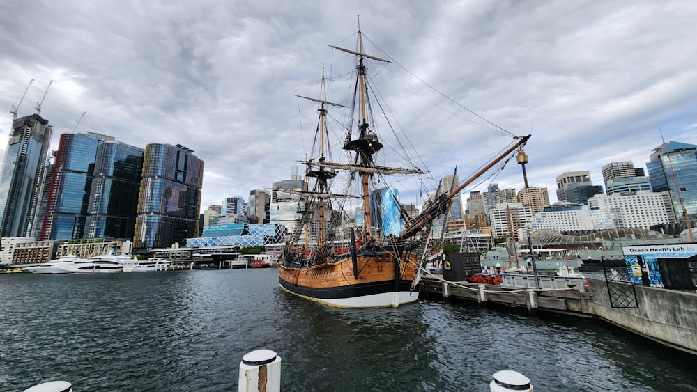 a large sailboat docked at a pier