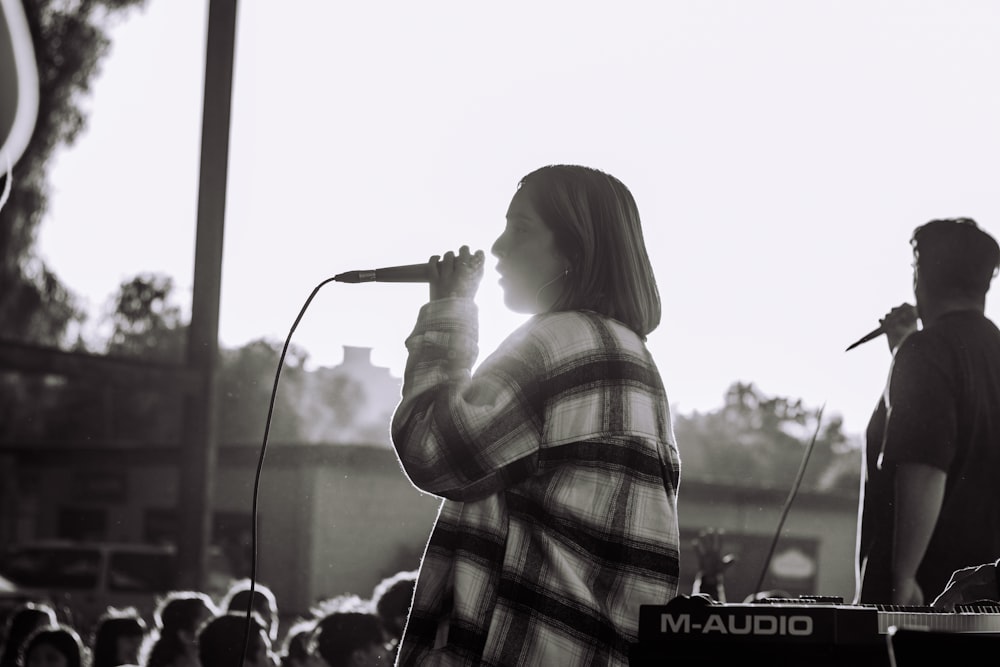 a person singing into a microphone