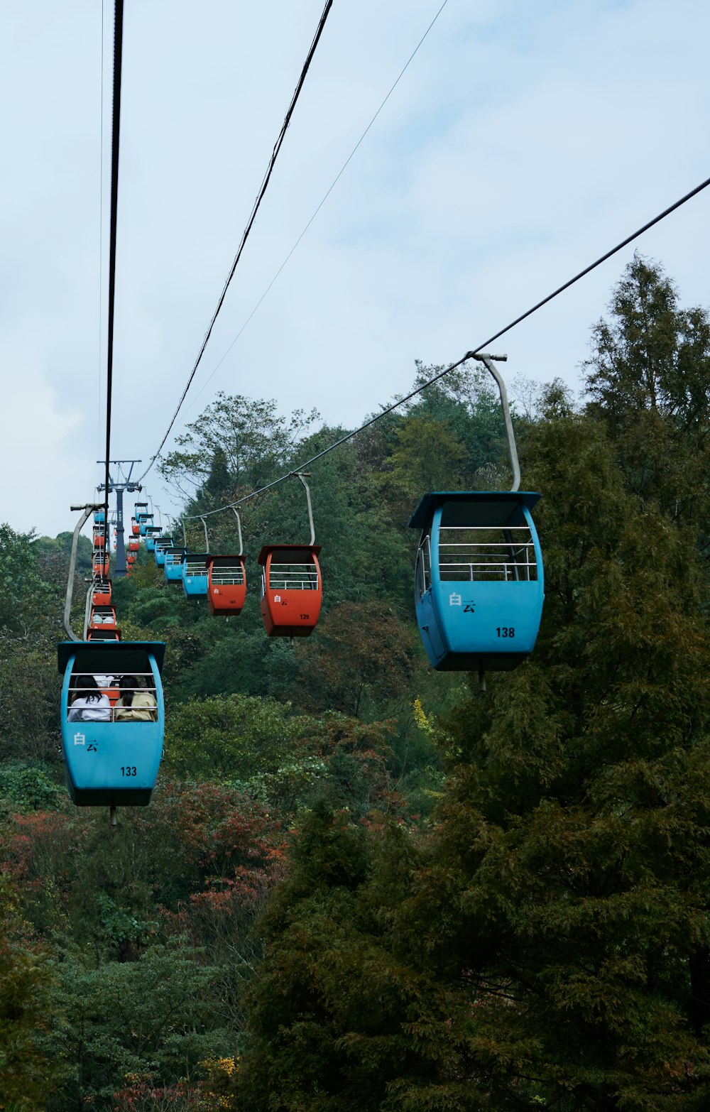 a group of people riding on a cable car