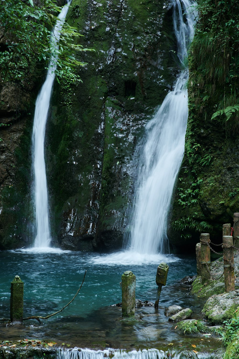 a waterfall with a rope