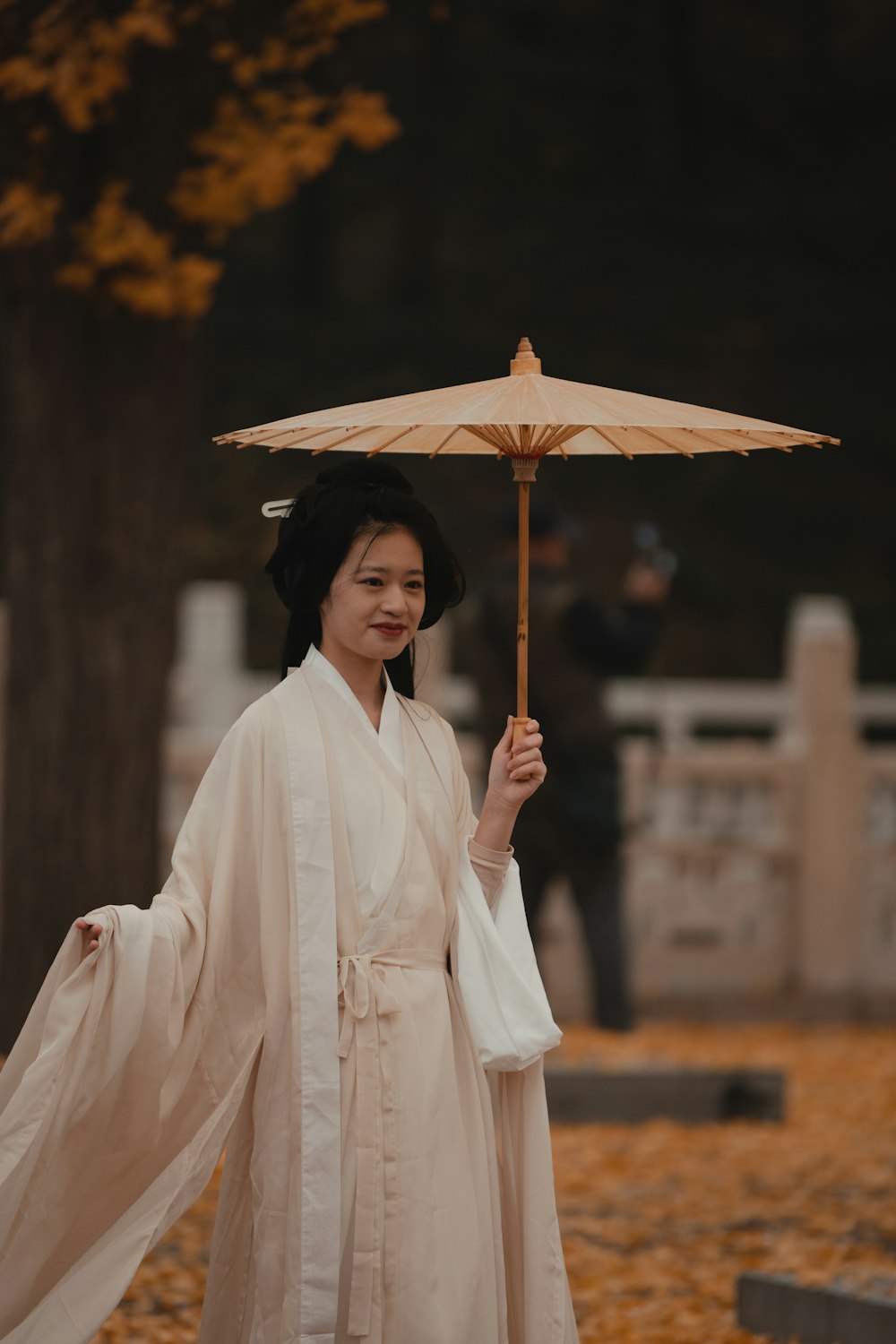 a person in a white dress holding an umbrella