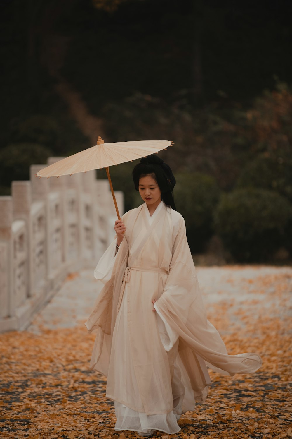 a person in a white dress holding an umbrella