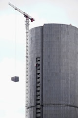 A crane lifting materials at a building site.